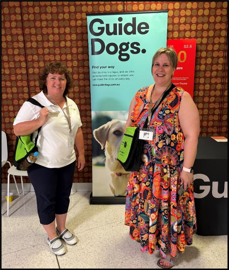 Figure 1 Julie and Alana at the OMAA Conference standing with the guide dogs flag.docx
