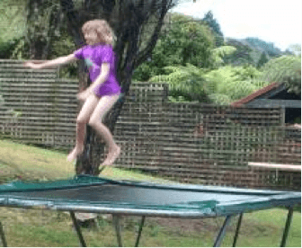 A child jumping on a trampoline.