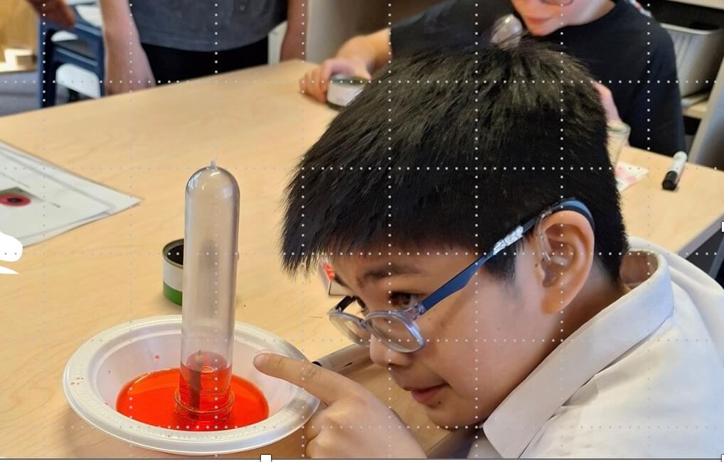 Ākonga enjoying watching a science experiment.