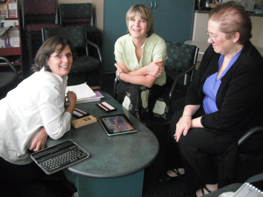 Cathy, Trish and Diane learning abacus skills with digital technology.