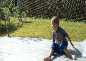 Boy zooming down a waterslide.