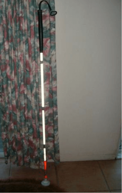Cane leaning against a curtain.