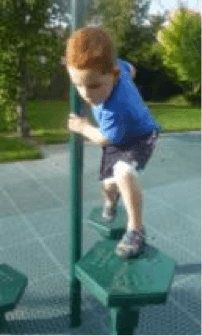 Child on playground stepping from one shaped platform to another holding a pole.