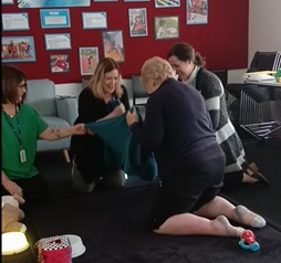 Figure 1 A toddler being swung in a blanket to calm him and regulate his sensory systems