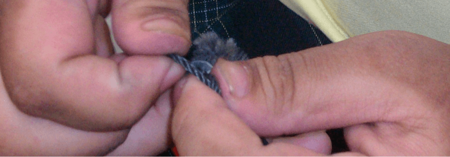 Hands holding string.