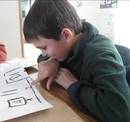 Learner sitting at a table with a map.