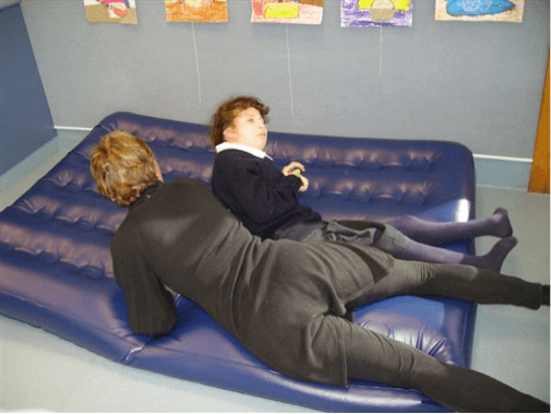 Sam and the O & M Specialist are lying on the airbed.