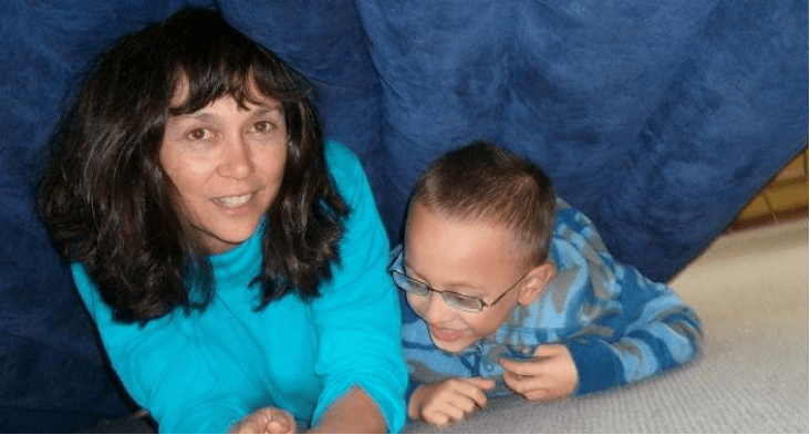 Student and his teacher aide lying under an airbed