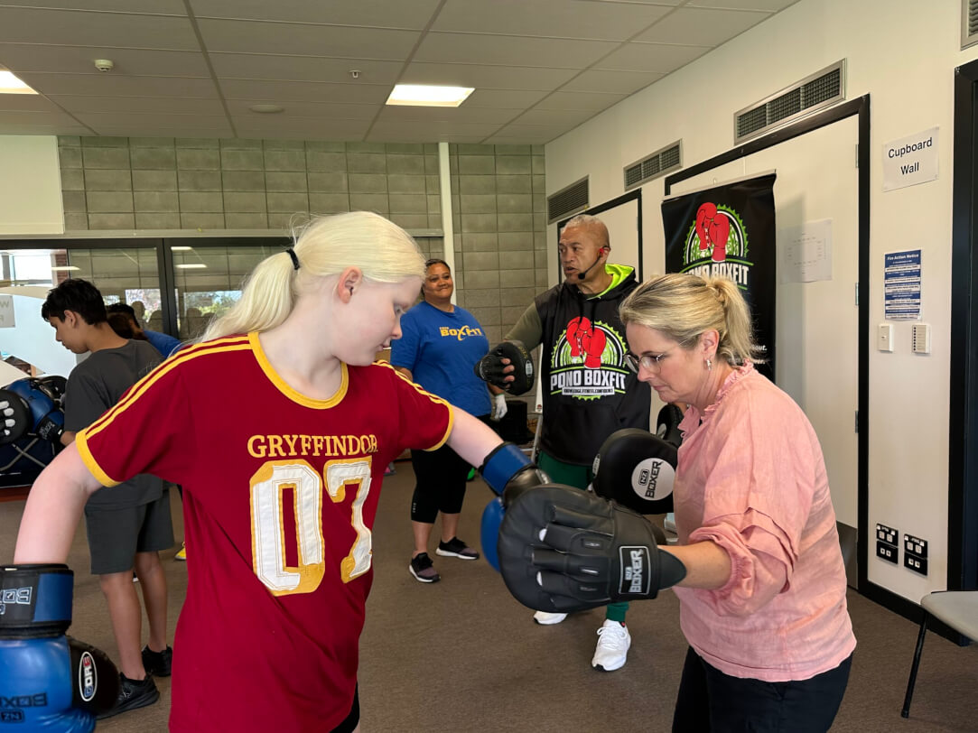 Transition staff working with akonga doing Boxfit scaled