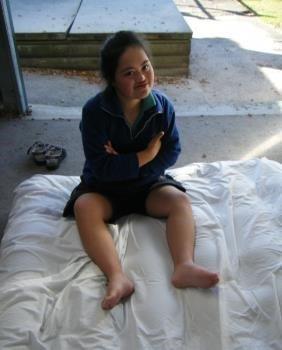 Young learner is sitting on an airbed.
