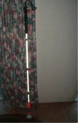 Cane leaning against a curtain