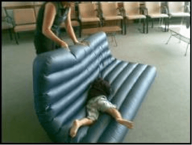 Child being rolled around on an airbed by O&M instructor