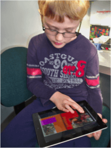 Child holding iPad scrolling through a book