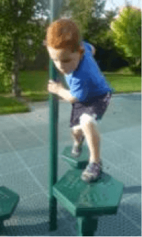 Child on playground stepping from one shaped platform to another holding a pole