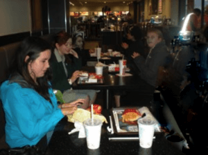 Five students sitting in booths at McDonalds
