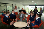 Len Brown sitting with students at morning tea