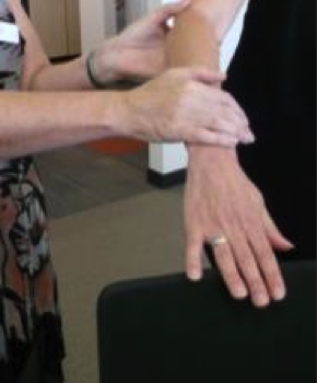 Person holding on to sighted guide's arm at the elbow, resting right hand on guide's forearm