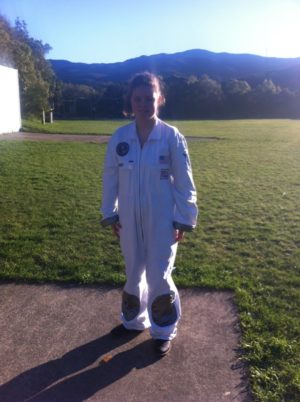 Renee standing outside wearing a white space suit