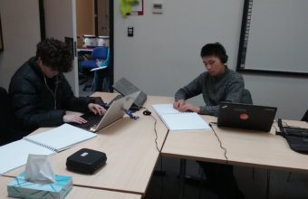 Two students reading and composing on BME