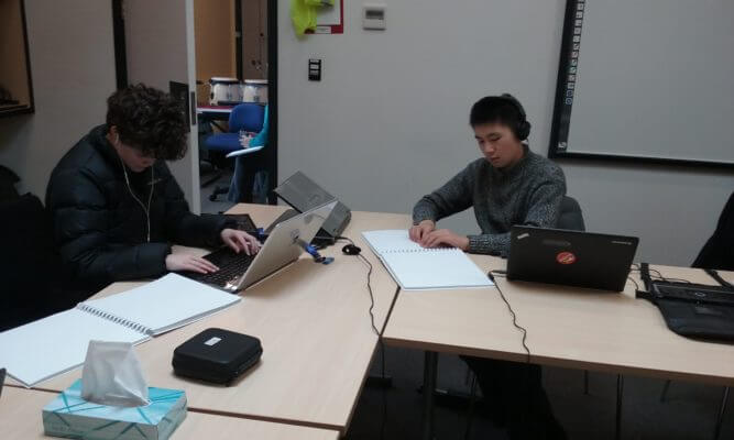 Two students reading and composing on BME