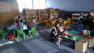 Children and parents sitting in music room