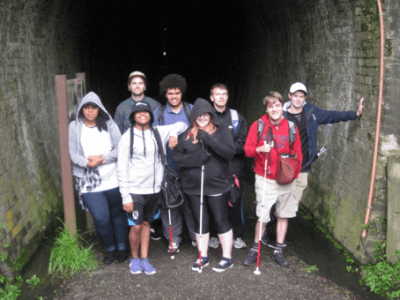 Eight students standing at start of tunnel