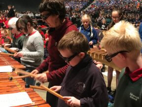 Four students with music teacher Virginia playing marimbas at Christchurch festival