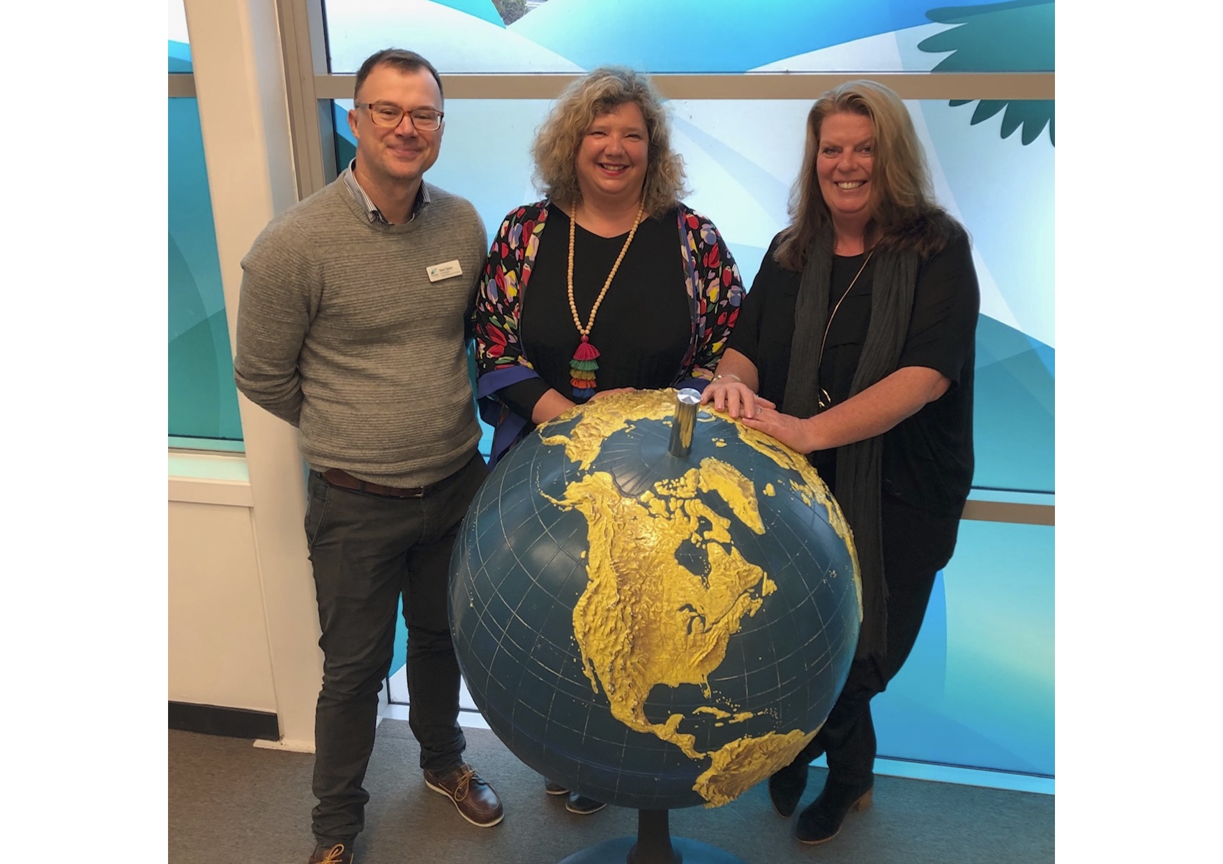 the 3 VRC Coordinators standing around the globe at Homai.