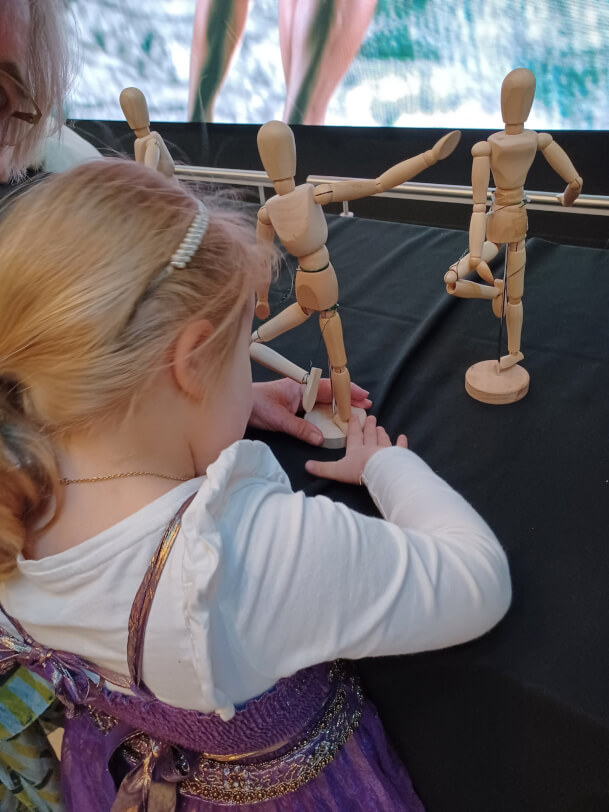 Figure 2 - Figure 2 - Child holding a wooden ballet figure