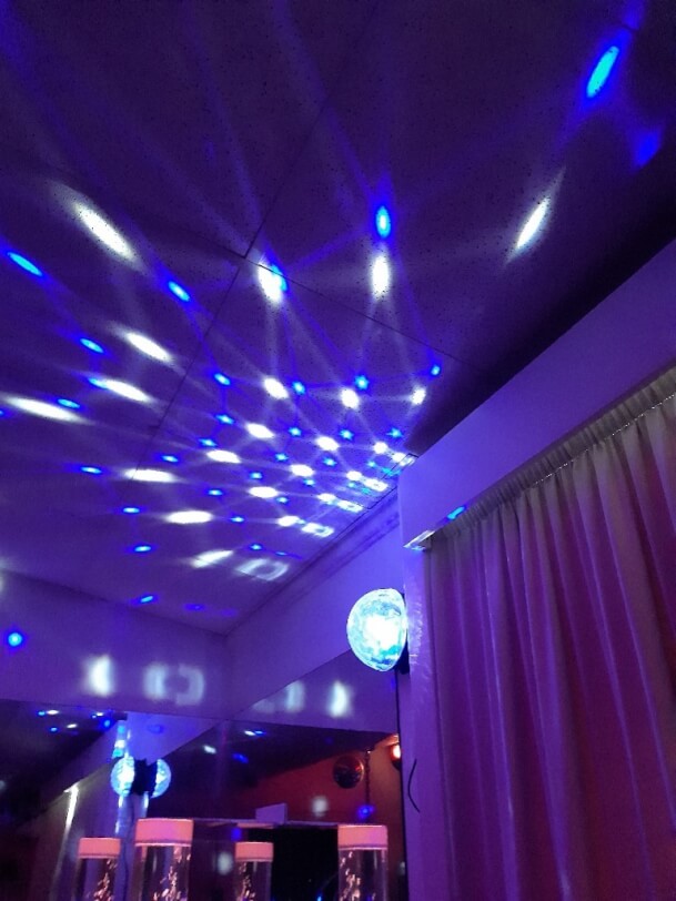 Figure 1 - Figure 1 - Mirror ball and lights shining on the ceiling in a sensory room