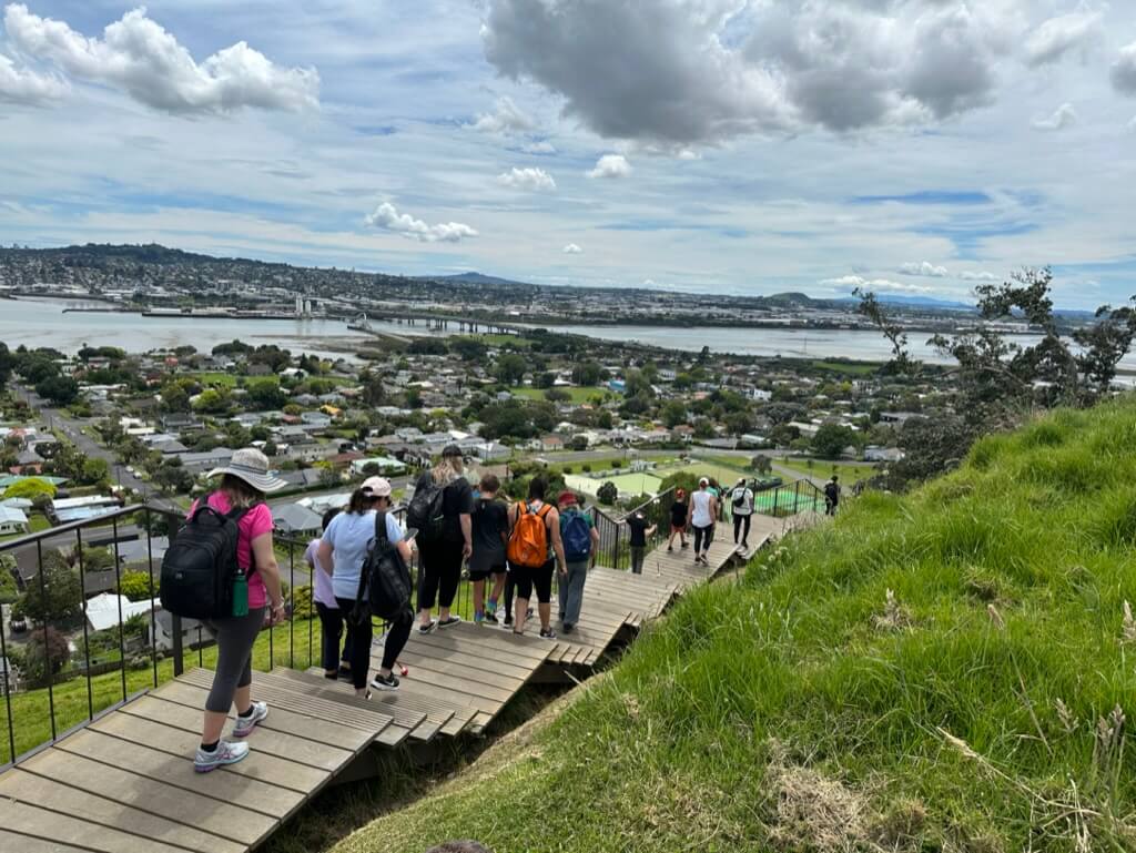 Figure 1 - Immersion ākonga and RTVs walking on Māngere Maunga going downhill on a boardwalk